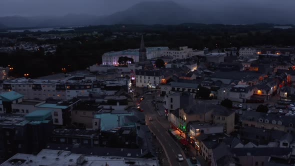 Aerial Footage of Town Centre with Church and Luxury Hotel at Dusk