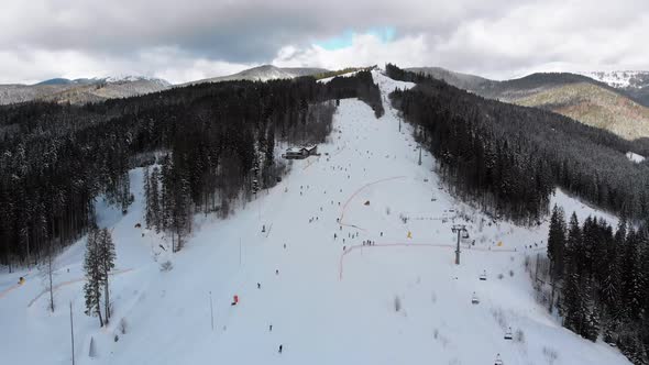 Aerial View on Ski Slopes with Skiers and Ski Lifts on Ski Resort in Winter