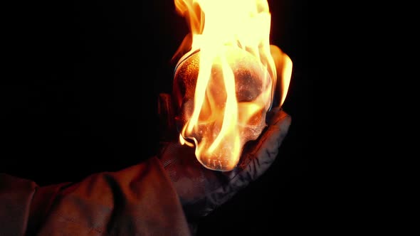 Flaming Skull Is Held Up And Flies Into Camera