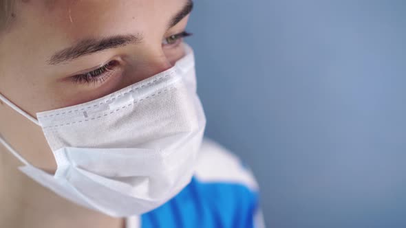 A young man takes off a protective medical mask