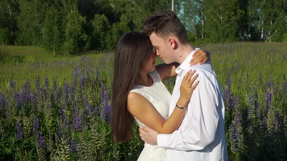 Mixed Race Teen Couple Hugging in Summer Field