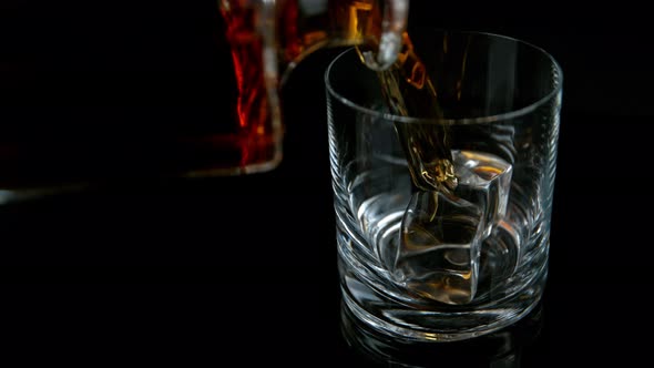 Super Slow Motion Shot of Pouring Whiskey Into Glass with Ice Cubes at 1000Fps with Camera Movement