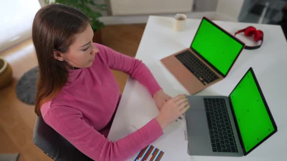 Exhausted Overworked Caucasian Woman Yawning Taking a Nap at Table with Green Screen Laptops