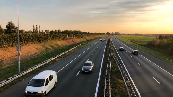 Highway with moving cars at sunset