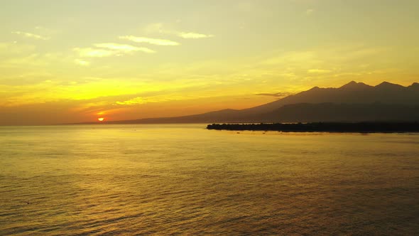 sunset over the beautiful philippine lagoon with small fishing boats in the foreground and mountains