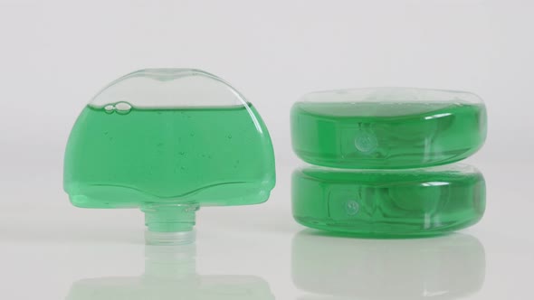 Green gel fresheners on white 4K tilting footage