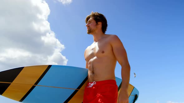 Bottom view of surfer man holding his surfboard 4k