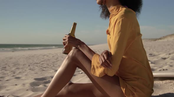 Woman drinking beer on the beach 4k