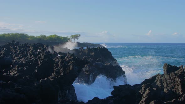 Waves crashing into shore on Hawaii