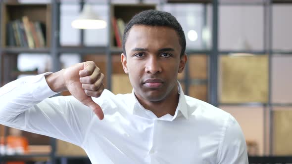 Thumbs Down by Black Man in Office