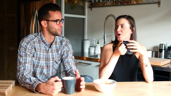 Couple interacting with eachother while having coffee