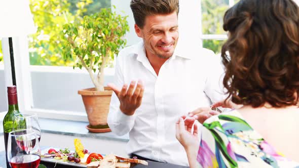 Woman proposing man with engagement ring