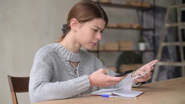 Young woman upset counting the amount of purchases in the store