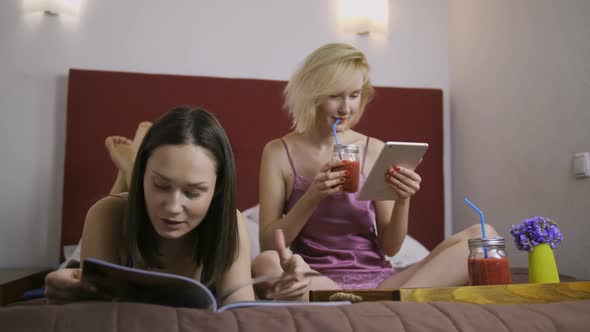 Cheerful Female Friends Having Fun in Bed at Home