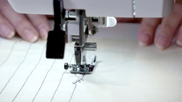 The Sewing Machine Needle Is in Motion. Close-up of a Needle Moving Up and Down Quickly. In a Sewing