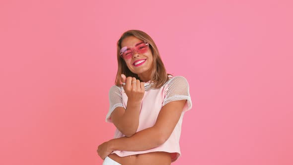 Model with Shiny Freckles and Tattooed Hands in Sunglasses and Top