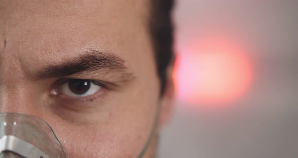 Close Up Portrait of Sick Young Man with Oxygen Mask Looking at Camera in Hospital