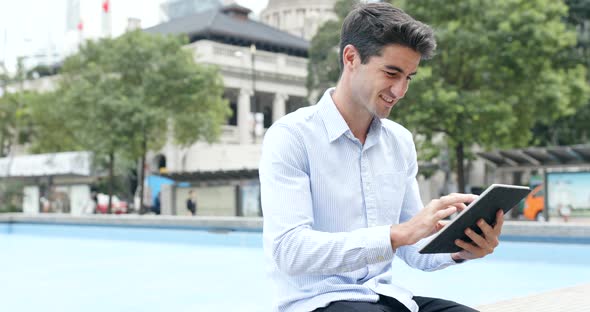 Businessman look at digital tablet computer at outdoor