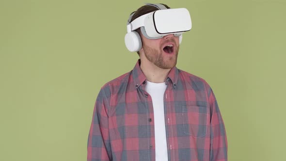 Man in 3d Glasses on a Yellow and Green Background in the Studio