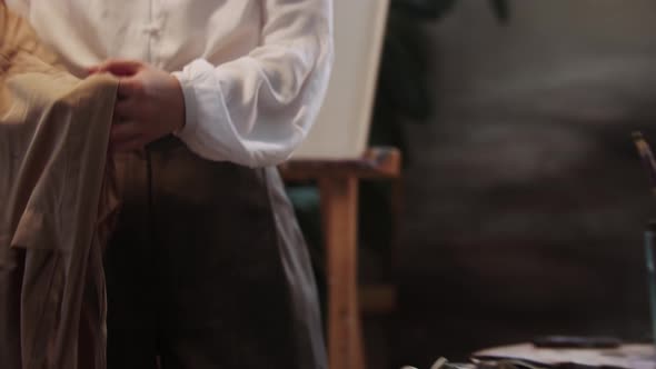 Young Woman Artist Puts on the Apron