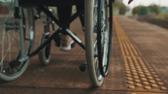 Close Up, Young Woman Steering the Wheel of the Wheelchair. 