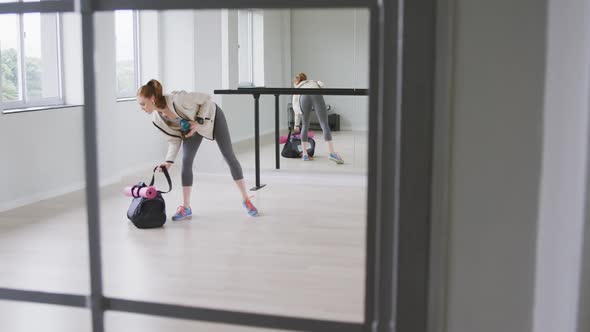 Caucasian female ballet dancer holding a sports bag