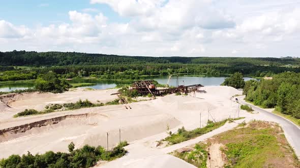 Sand and gravel digging site with industrial equipment, aerial drone view