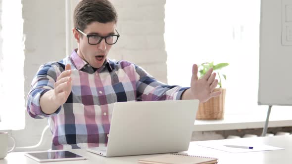 Upset Young Man Reacting to Failure of Project