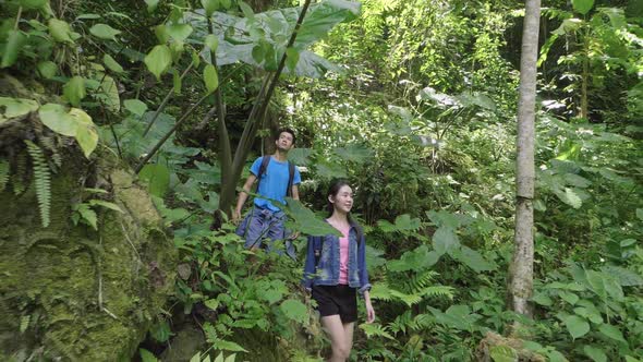 Young Couple Enjoying Hiking In The Fores