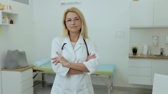 Portrait of Confident Female Doctor Standing in Hospital Medical Office Looking at Camera with