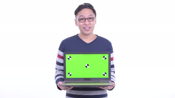 Happy Japanese Hipster Man Talking While Showing Laptop