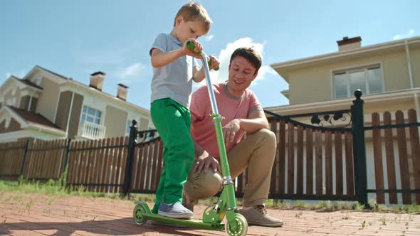 Teaching Child to Ride a Scooter