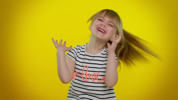 Funny Child Girl in Striped Tshirt Listening Music Smiling Dancing to Disco Music Having Fun