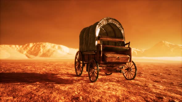 Canvas Covered Retro Wagon in Desert at Sunset alt