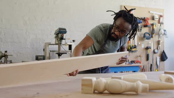 Carpenter measuring wooden plank 4k