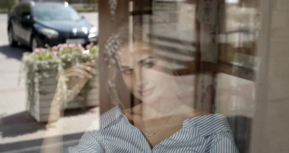 Girl Tenderly Smiling Sitting By The Window