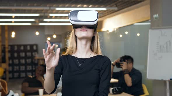 Handsome Young Woman in Virtual Reality VR Glasses Working in the Office