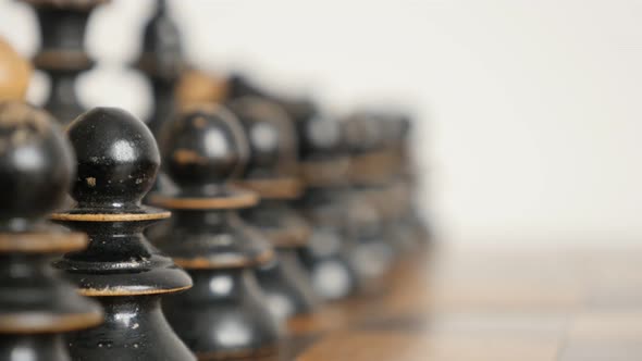 Row of chess set figures arranged on  table close-up 4K 2160p 30fps UltraHD  footage - Black player  alt