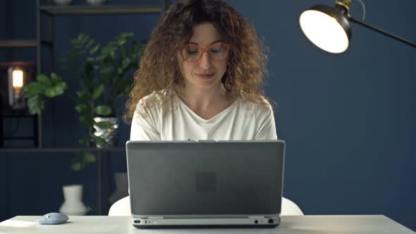 Portrait of a Middleaged Woman Working at a Laptop