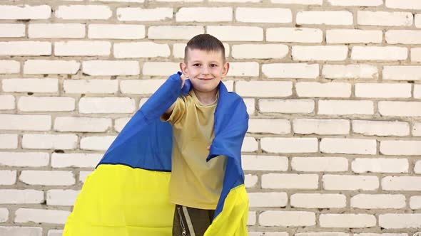 smiling adorable Ukrainian boy is happy with the victory of his country. children against war. 