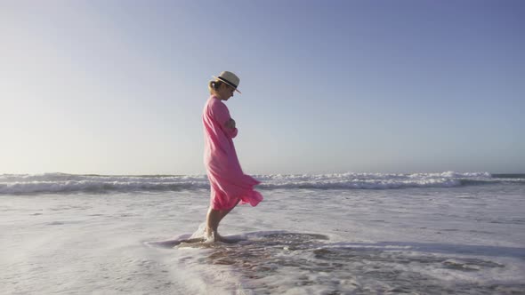 Stylish Happy American Woman Playing with Ocean Waves Fun on Beach at Sunset 6K