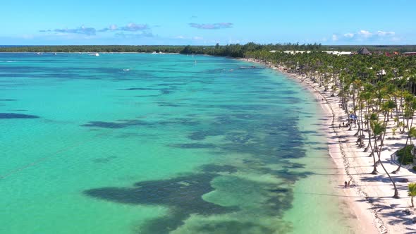 Tropical Coastline with Resorts Palm Trees and Caribbean Sea with Floating Boats and People Having