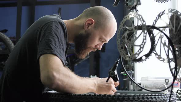 Concentrated man repairing the wheel