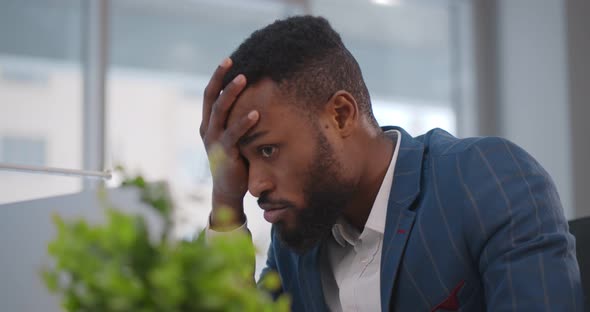 Close Up of Stressed and Upset African Man with Laptop Working at Office