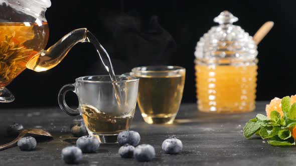 Tea Being Poured Into Glass Transparent Tea Cup in Slow Motion