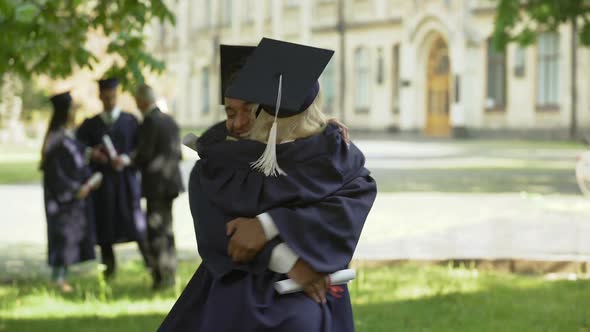 University graduates talking and hugging, student couple, love and relationship