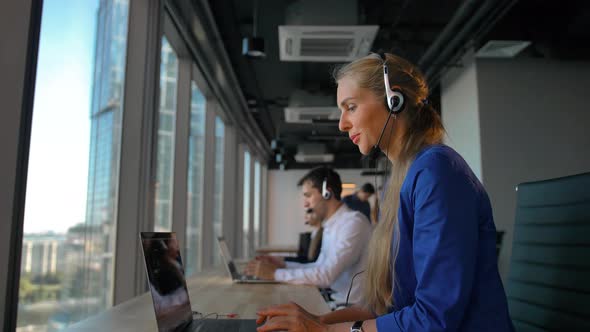 Young Businesswoman Talking on Headset with Great Smile