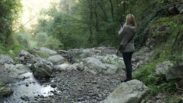 Taking  pictures under natural stone bridge 4K 2160p 30fps UltraHD footage - Nature and forest in Ea