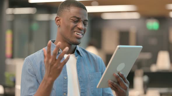 Young African American Man Having Loss on Tablet