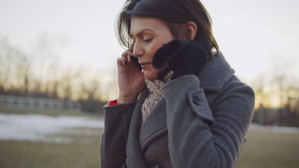 Business Woman Walking and Talking on the Phone